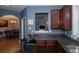 Efficient kitchen layout featuring dark wood cabinets and view into adjacent dining area at 2353 Maplewood Se Ct # 25, Atlanta, GA 30339