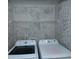Laundry room with Samsung washer and dryer, and wall-mounted wire shelf at 2353 Maplewood Se Ct # 25, Atlanta, GA 30339