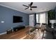 Well-lit living room with TV, front door access, and ceiling fan is perfect for entertaining and relaxing at 2353 Maplewood Se Ct # 25, Atlanta, GA 30339
