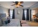 Main bedroom with king bed, ceiling fan, and large windows at 2353 Maplewood Se Ct # 25, Atlanta, GA 30339