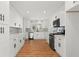 Modern kitchen with white cabinets, quartz countertops, and stainless steel appliances at 3781 Hickory Ridge Ct, Marietta, GA 30066