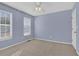 Light-purple bedroom with carpet and two windows at 3945 Brushy Creek Way, Suwanee, GA 30024