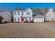 Two-story house with white siding, red door, and attached garage at 3945 Brushy Creek Way, Suwanee, GA 30024