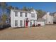 Two-story house with white siding, red door, and attached garage at 3945 Brushy Creek Way, Suwanee, GA 30024