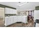 Modern kitchen with white cabinets, stainless steel appliances and an island at 3945 Brushy Creek Way, Suwanee, GA 30024