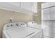 Bright laundry room with Whirlpool washer and dryer at 3945 Brushy Creek Way, Suwanee, GA 30024