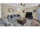 Living room featuring hardwood floors, a ceiling fan, and ample natural light at 3945 Brushy Creek Way, Suwanee, GA 30024