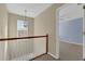 Upstairs hallway with light walls and a view to another bedroom at 3945 Brushy Creek Way, Suwanee, GA 30024