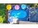 Aerial view of a luxurious pool and deck area with colorful umbrellas at 4692 Yeager Rd, Douglasville, GA 30135