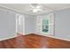 Bright bedroom with hardwood floors, window shutters, and ceiling fan at 4692 Yeager Rd, Douglasville, GA 30135