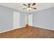 Hardwood floor bedroom with ceiling fan and double closets at 4692 Yeager Rd, Douglasville, GA 30135