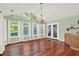 Sun-filled dining room with hardwood floors, chandelier and multiple windows at 4692 Yeager Rd, Douglasville, GA 30135