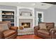 Living room with fireplace, built-in shelving and hardwood floors at 4692 Yeager Rd, Douglasville, GA 30135