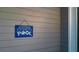 Blue welcome to our pool sign on gray siding at 4692 Yeager Rd, Douglasville, GA 30135