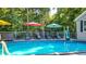 Relaxing in-ground pool with deck, umbrellas, and lounge chairs at 4692 Yeager Rd, Douglasville, GA 30135