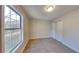 Well-lit bedroom with large window and carpet at 550 Jodeco Station St, Stockbridge, GA 30281