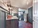 Modern bathroom with patterned wallpaper, gray wainscoting, and brick floor at 731 E Main St, Canton, GA 30114