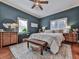 Spacious bedroom with a ceiling fan, wooden dresser, and blue walls at 731 E Main St, Canton, GA 30114