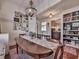 Bright dining room with an oval table, gallery wall, and view into kitchen at 731 E Main St, Canton, GA 30114