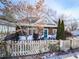 Charming cottage with wood siding, rocking chairs, and a picket fence at 731 E Main St, Canton, GA 30114