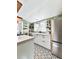 Bright kitchen with white cabinets, farmhouse sink, and star patterned floor at 731 E Main St, Canton, GA 30114