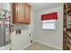 Laundry room with wood cabinets, tile floor, and a water heater at 5694 Cub Ct, Stone Mountain, GA 30087