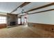 Bright living room with a stone fireplace and wood beams at 5694 Cub Ct, Stone Mountain, GA 30087