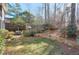 Landscaped backyard with stone retaining wall and fire pit area at 1103 Ridenour Ct, Kennesaw, GA 30152