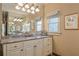 Elegant bathroom features granite countertops, white cabinets, and a large mirror at 1103 Ridenour Ct, Kennesaw, GA 30152