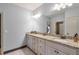 Double vanity bathroom with granite countertops and white cabinets at 1103 Ridenour Ct, Kennesaw, GA 30152