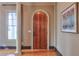 Elegant entryway with an arched wooden door and hardwood floors at 1103 Ridenour Ct, Kennesaw, GA 30152