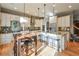 Bright kitchen with white cabinets, granite countertops, and an island at 1103 Ridenour Ct, Kennesaw, GA 30152