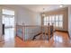 Upstairs hallway with hardwood floors, elegant railing, and natural light at 1103 Ridenour Ct, Kennesaw, GA 30152