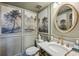 Elegant powder room with marble vanity and nature-themed wallcovering at 15 Independence Nw Pl, Atlanta, GA 30318