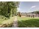 Paved pathway meanders through grassy area towards a brick building and pool at 15 Independence Nw Pl, Atlanta, GA 30318