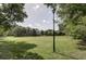 Open green field with a lamppost, providing a tranquil area at 15 Independence Nw Pl, Atlanta, GA 30318