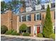 Two-story brick home with a red door and lush landscaping at 15 Independence Nw Pl, Atlanta, GA 30318