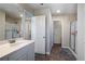 Bright bathroom features a vanity, mirror, glass shower and wood-look floors at 150 Auburn Depot Dr, Auburn, GA 30011