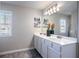 Bright bathroom featuring double sink vanity with great lighting and wood look floors at 150 Auburn Depot Dr, Auburn, GA 30011