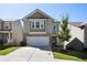 Two-story home with neutral siding and a two-car garage at 150 Auburn Depot Dr, Auburn, GA 30011