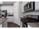 Modern kitchen with stainless steel appliances and granite countertops at 150 Auburn Depot Dr, Auburn, GA 30011