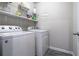 Laundry room features washer, dryer, shelving, and laundry-themed wall decor at 150 Auburn Depot Dr, Auburn, GA 30011