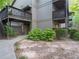 Exterior view of condo building with walkway and landscaping at 2710 Se Cumberland Court, Smyrna, GA 30080