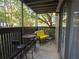 Covered patio with yellow couch and small table at 2710 Se Cumberland Court, Smyrna, GA 30080