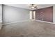 Large bedroom with grey walls and plush carpeting at 527 Mossycup Dr, Fairburn, GA 30213