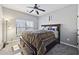 King-size bedroom with ceiling fan and ample closet space at 527 Mossycup Dr, Fairburn, GA 30213