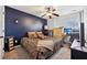 Spacious bedroom with dark blue accent wall, king-size bed, and workspace at 527 Mossycup Dr, Fairburn, GA 30213