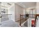 Upstairs hallway with iron railings and carpeted flooring at 527 Mossycup Dr, Fairburn, GA 30213