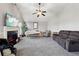 Relaxing living room featuring a fireplace and large TV at 527 Mossycup Dr, Fairburn, GA 30213