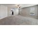 Spacious living room with grey walls and grey carpeting at 527 Mossycup Dr, Fairburn, GA 30213